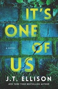 IT'S ONE OF US by J.T. Ellison book cover featuring light blue washed bricks (possible walkway/street) with green moss growing between the bricks and blades of grass at the bottom right and left edge of cover; title is in all caps down the cover in yellow lettering, the author's name is at the bottom center in white lettering