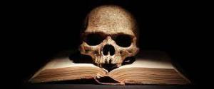 A weathered human skull resting on an open book